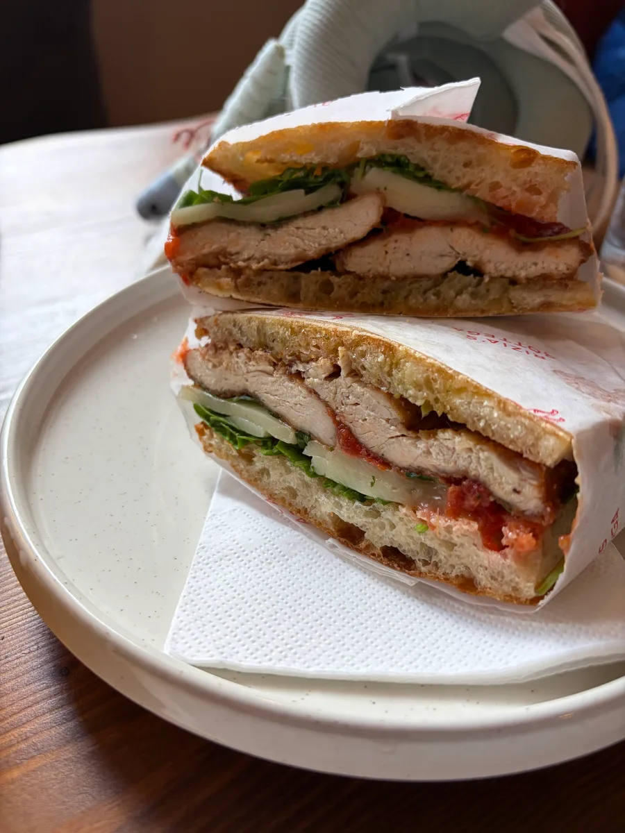 A generous chicken schiacciata sandwich at Rizia’s Bottega