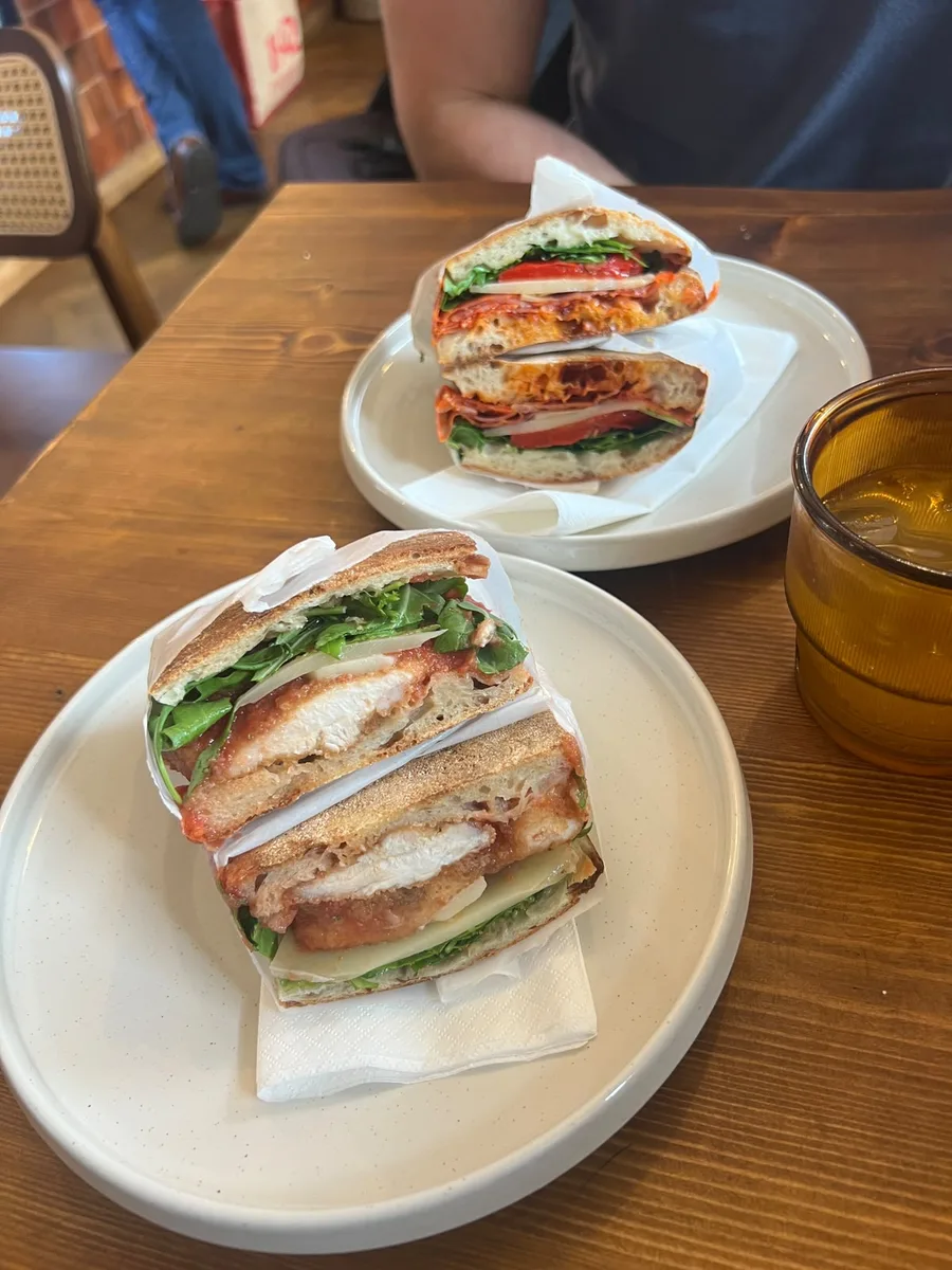 Filled schiacciata sandwiches served at a table in the bottega
