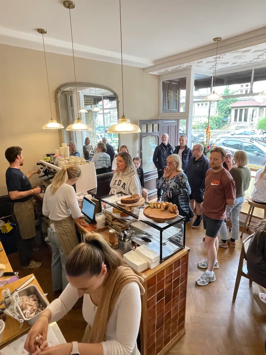 Neighbours gathered around the coffee counter inside Rizia’s Bottega