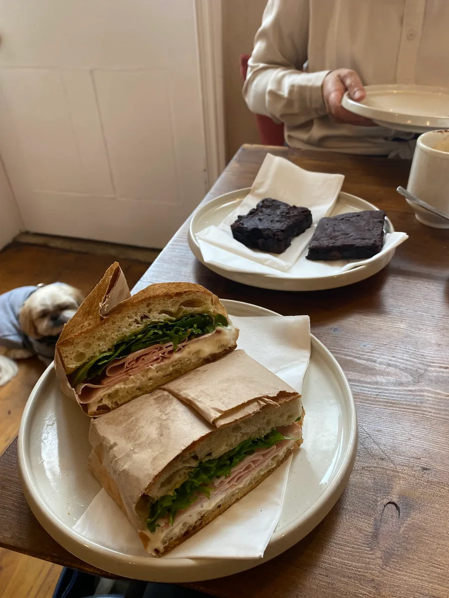 Sandwiches and chocolate cake shared at a cafe table
